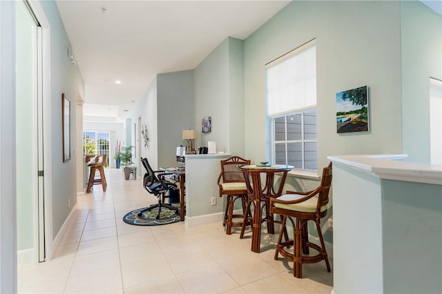 hallway with tile patterned flooring, recessed lighting, and baseboards