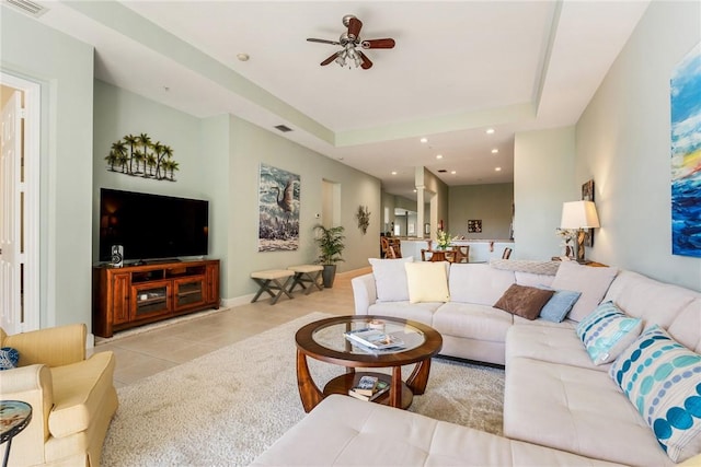 living room with visible vents, a ceiling fan, recessed lighting, light tile patterned floors, and a raised ceiling