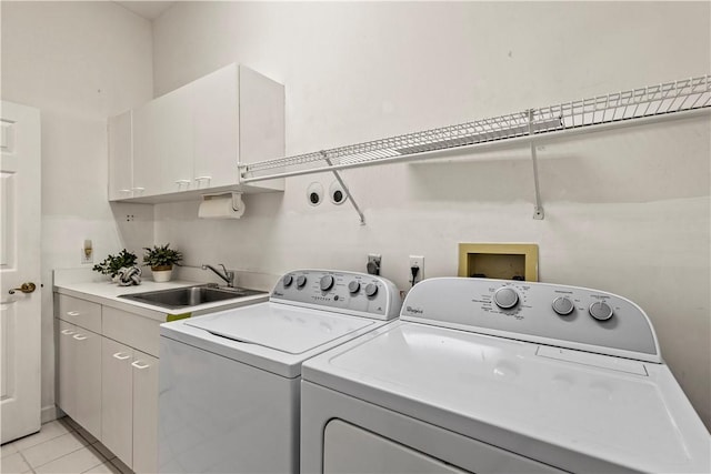 washroom with cabinets, independent washer and dryer, sink, and light tile patterned floors