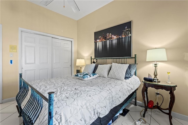 bedroom featuring light tile patterned floors, a closet, and ceiling fan