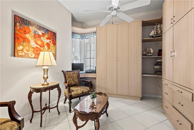 sitting room featuring light tile patterned floors and ceiling fan