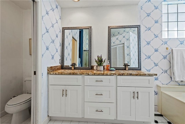 bathroom featuring tile patterned floors, vanity, and toilet