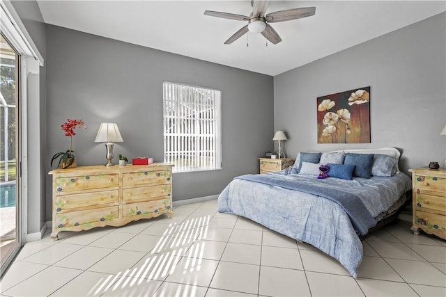 tiled bedroom featuring ceiling fan