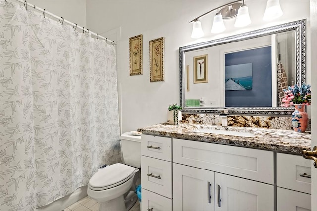 bathroom featuring tile patterned floors, vanity, and toilet