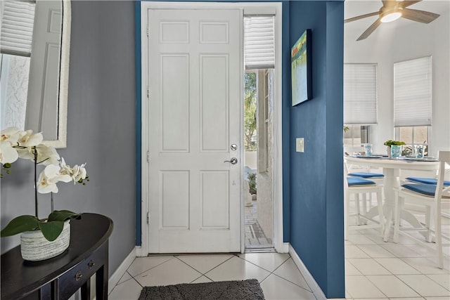 tiled entryway featuring plenty of natural light and ceiling fan