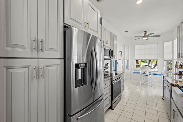 kitchen with light tile patterned floors, ceiling fan, white cabinets, and appliances with stainless steel finishes