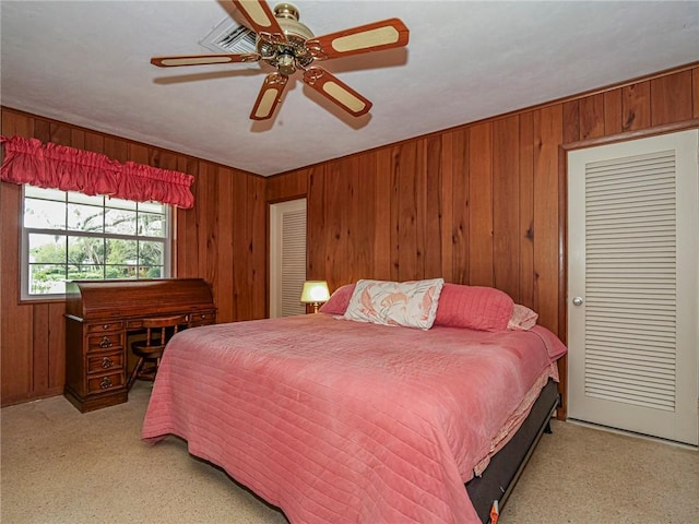 bedroom featuring wood walls and ceiling fan