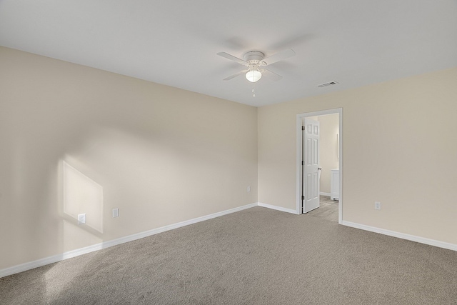 spare room featuring ceiling fan and light colored carpet