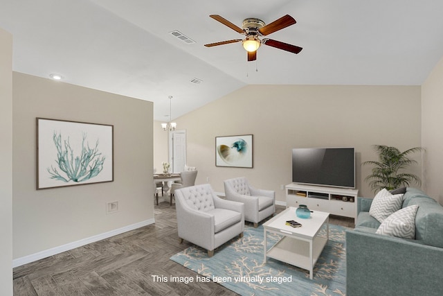 living room with ceiling fan with notable chandelier, dark parquet flooring, and vaulted ceiling