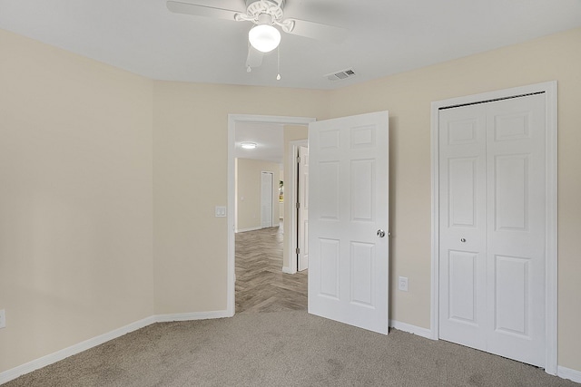 unfurnished bedroom with ceiling fan and carpet floors