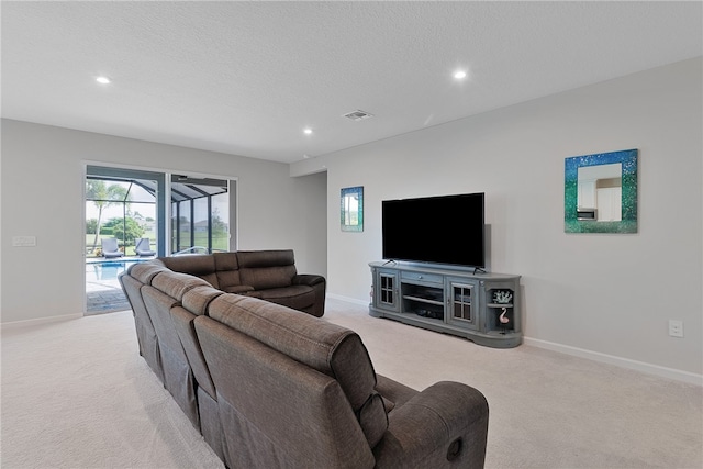 carpeted living room featuring a textured ceiling