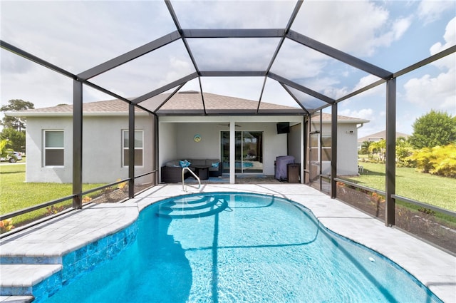 view of swimming pool with glass enclosure, a patio area, and a lawn