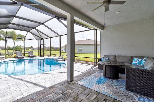 view of swimming pool with glass enclosure, a patio, outdoor lounge area, and ceiling fan