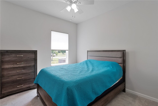 bedroom featuring ceiling fan and light carpet