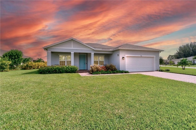 ranch-style home featuring a garage and a yard