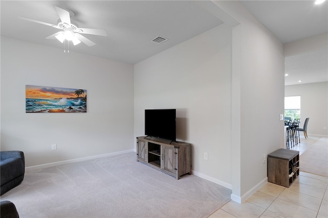 living room featuring light tile patterned floors and ceiling fan