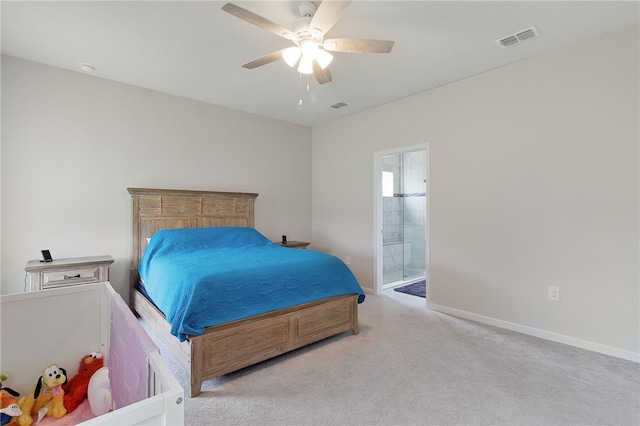 bedroom with light colored carpet, ensuite bath, and ceiling fan