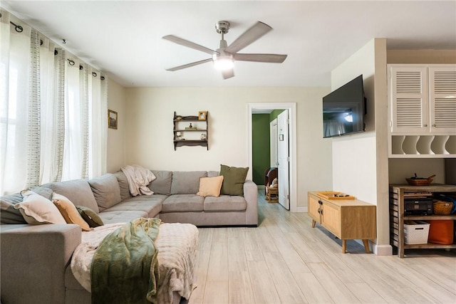 living room featuring ceiling fan and light hardwood / wood-style floors