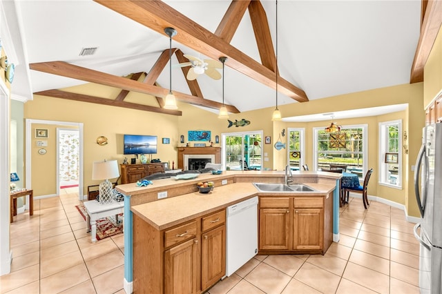 kitchen with sink, hanging light fixtures, stainless steel refrigerator, and dishwasher