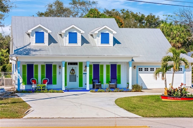 new england style home featuring covered porch and a front yard