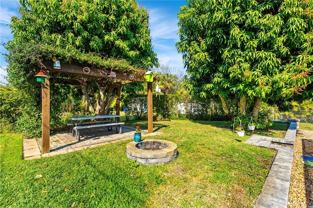 view of yard featuring an outdoor fire pit