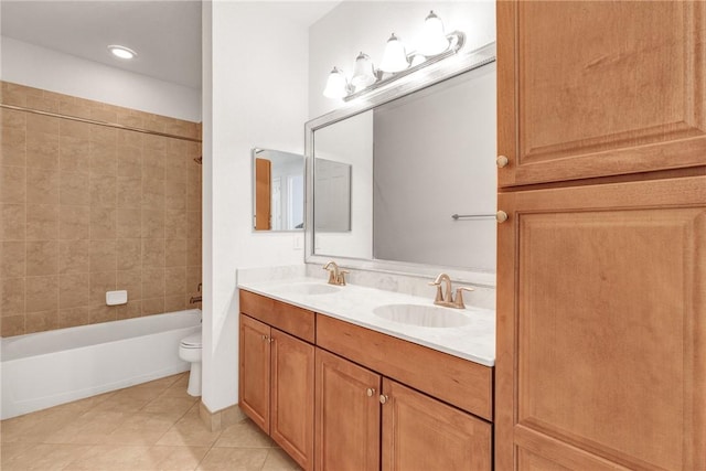 full bathroom with tiled shower / bath, vanity, toilet, and tile patterned flooring