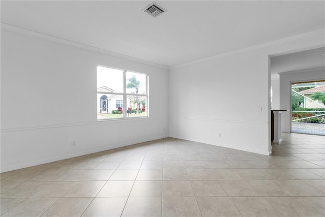 unfurnished room featuring ornamental molding and light tile patterned flooring