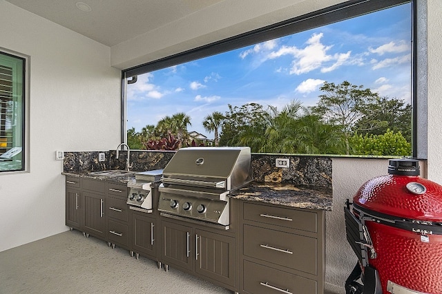 view of patio with area for grilling, sink, and an outdoor kitchen