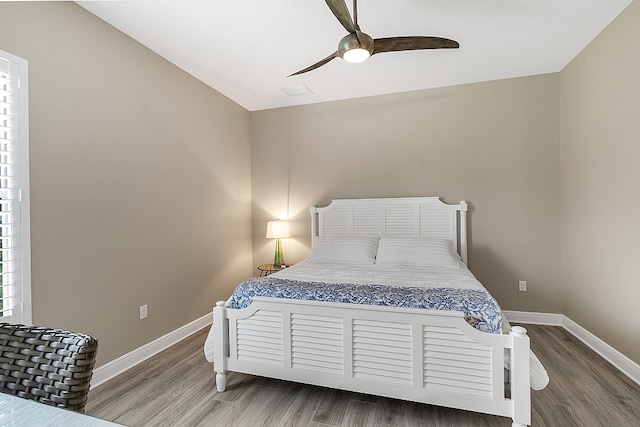 bedroom with ceiling fan, wood-type flooring, and vaulted ceiling