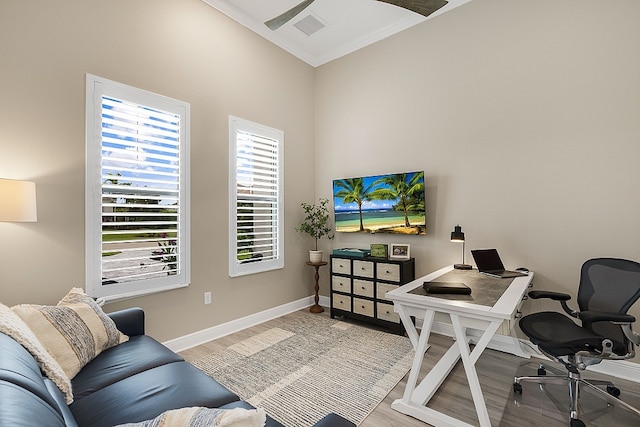 office space with light wood-type flooring and crown molding