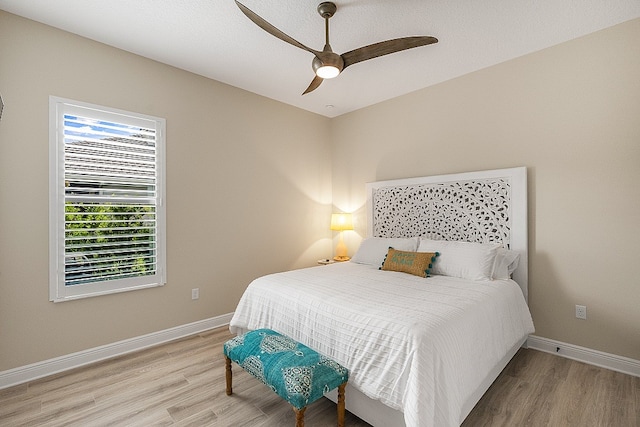 bedroom with hardwood / wood-style floors and ceiling fan