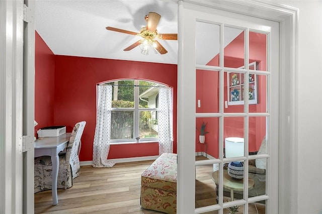 interior space with ceiling fan and wood finished floors