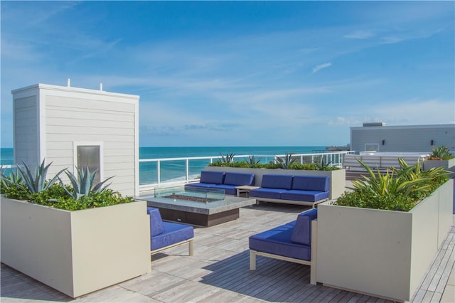 deck with outdoor lounge area and a water view