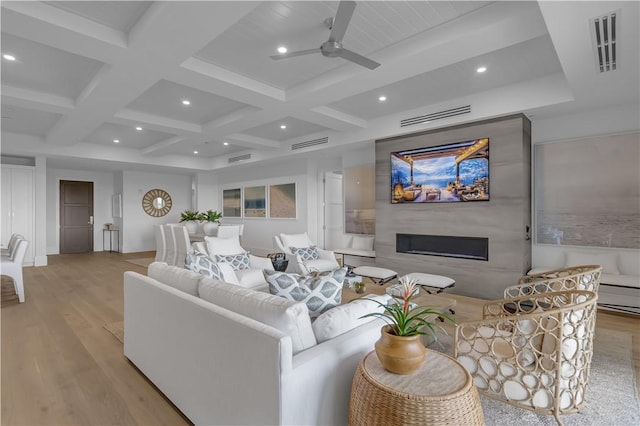 950 Surfsedge Way Unit 205, Vero Beach, FL 32963 - living area with light wood-style floors, a glass covered fireplace, a ceiling fan, beam ceiling, and coffered ceiling