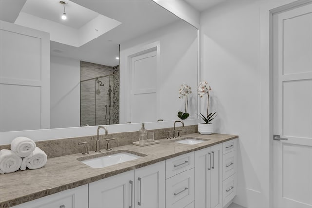 bathroom with vanity, a raised ceiling, and an enclosed shower