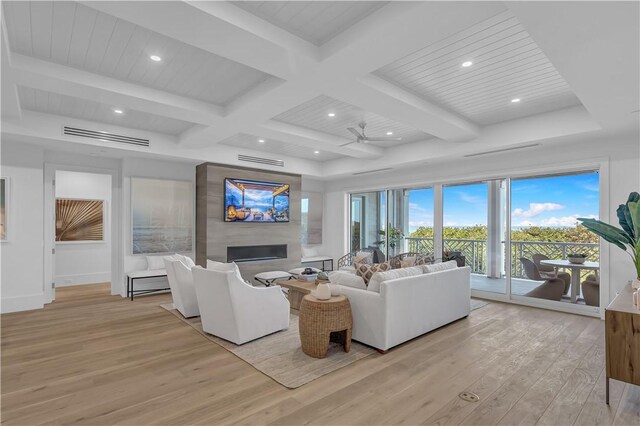 950 Surfsedge Way Unit 205, Vero Beach, FL 32963 - living area featuring light wood-type flooring, a fireplace, coffered ceiling, beam ceiling, and recessed lighting