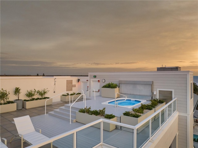 pool at dusk with a patio area