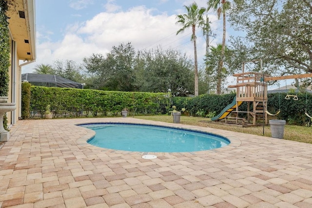 view of pool featuring a patio and a playground