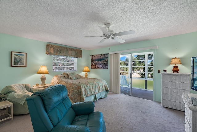 carpeted bedroom featuring a textured ceiling, ceiling fan, and access to exterior