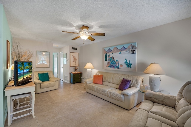 tiled living room featuring a textured ceiling and ceiling fan