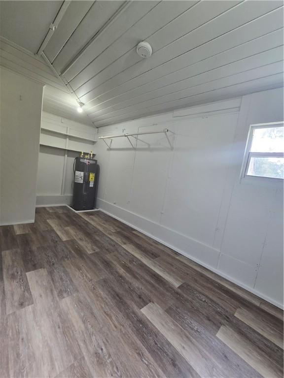 garage with electric water heater and baseboards