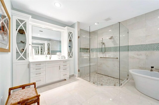 280 Seabreeze Ct, Vero Beach, FL 32963 - bathroom featuring a stall shower, vanity, a freestanding bath, and recessed lighting