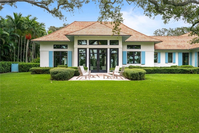 rear view of house featuring a yard and french doors