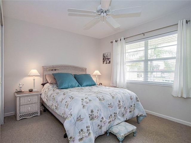 carpeted bedroom featuring a ceiling fan and baseboards