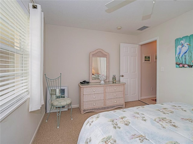 bedroom featuring carpet, multiple windows, visible vents, and baseboards