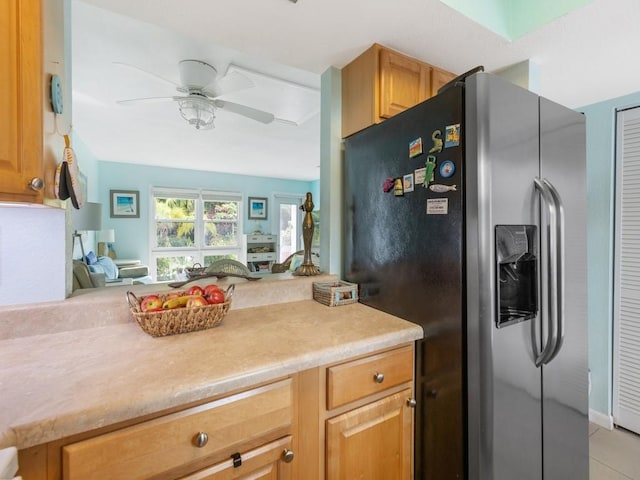 kitchen with ceiling fan, light tile patterned floors, and stainless steel fridge