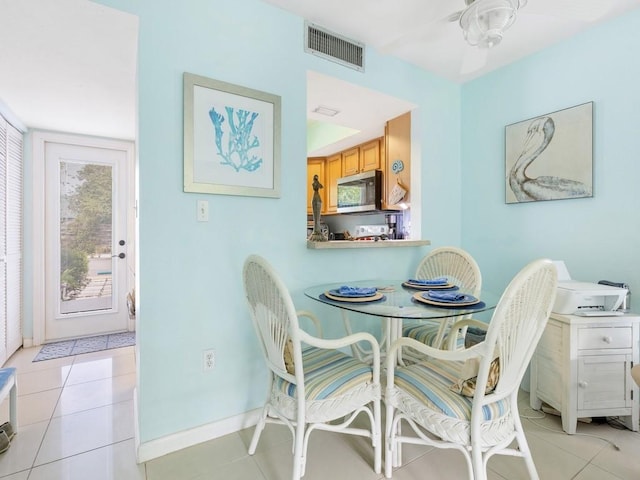 dining area with ceiling fan and light tile patterned floors