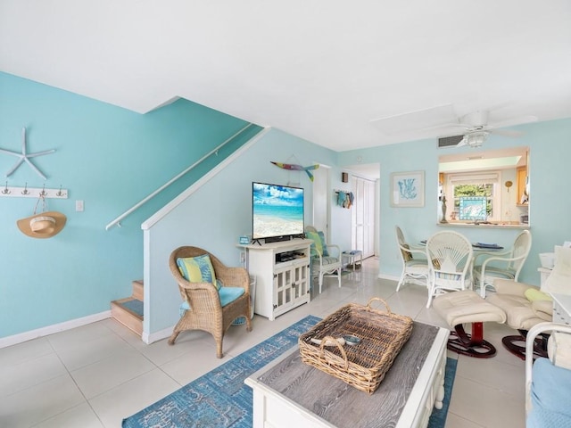 living room with ceiling fan and light tile patterned floors