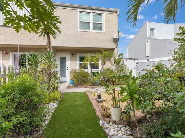 rear view of property featuring a yard