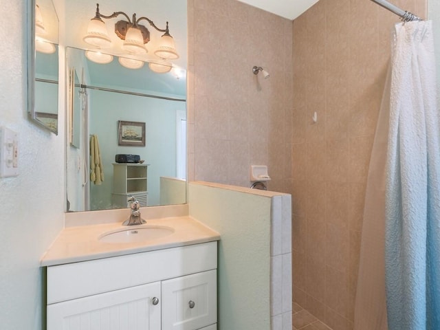 bathroom featuring walk in shower and vanity